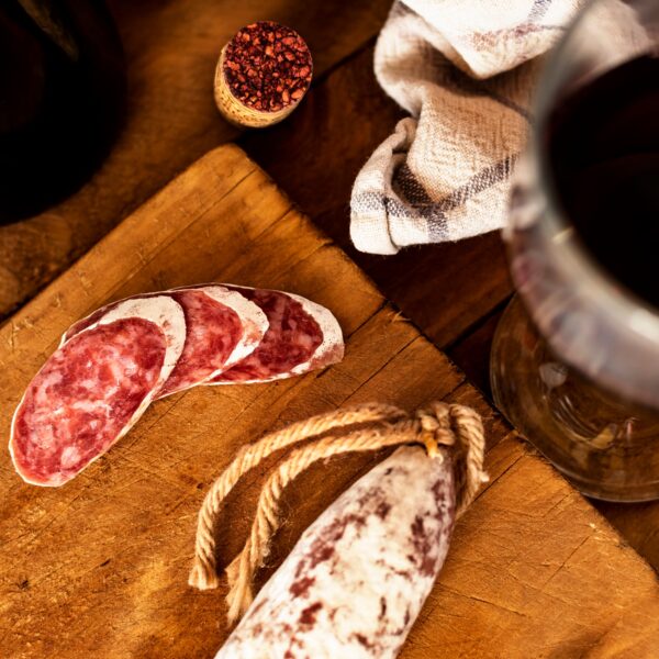Wooden kitchen table with a fuet (typical Catalan sausage)